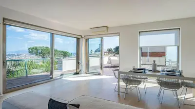 a living room with a table and chairs and glass doors at EasyTopStay - Rome from above Apt with a view in Rome