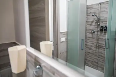 a bathroom with two toilets and a mirror at Domus Garbatella in Rome
