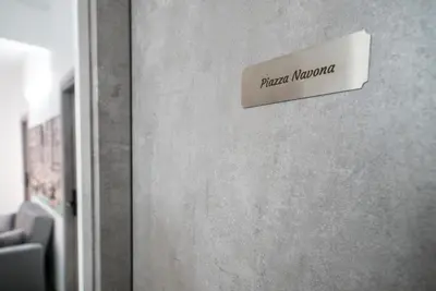 a sign on a wall that reads principal morgue at Domus Garbatella in Rome
