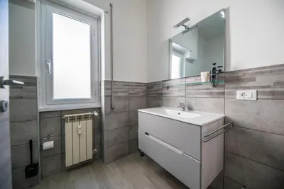 a bathroom with a sink and a mirror at Domus Garbatella in Rome
