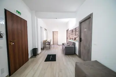 a hallway with a door and a living room at Domus Garbatella in Rome