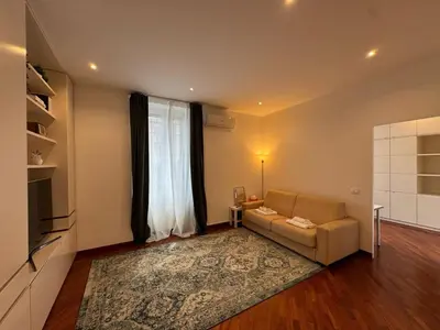 a living room with a couch and a large window at St John Apartment in Rome in Rome