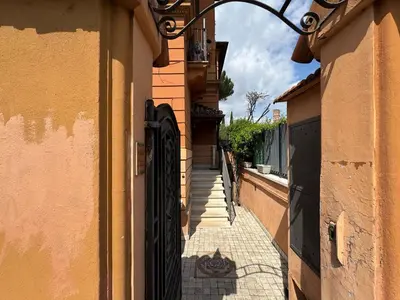 an alley between two buildings with a black gate at St John Apartment in Rome in Rome