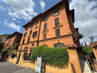 a large orange building with a hedge in front of it at St John Apartment in Rome in Rome