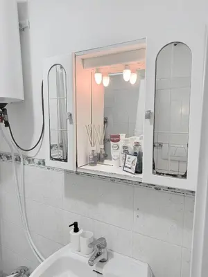 a bathroom with a sink and two mirrors at Roma Comfort Inn in Rome
