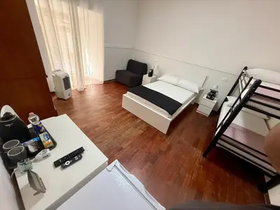 a small room with a bed and a desk at Roma Comfort Inn in Rome