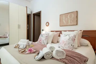 a bedroom with a bed with towels on it at RomAntica Laterano in Rome
