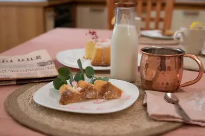 a table with two plates of food and a bottle of milk at RomAntica Laterano in Rome