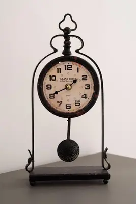 a clock sitting on top of a table at RomAntica Laterano in Rome