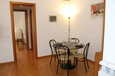 a dining room with a table with chairs and a lamp at Interno 10 in Rome
