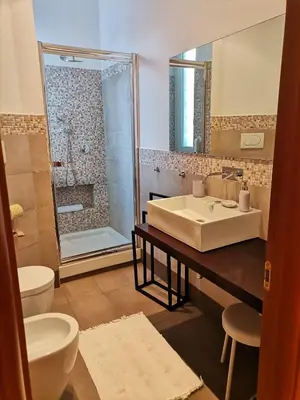a bathroom with a sink and a toilet and a shower at Interno 10 in Rome