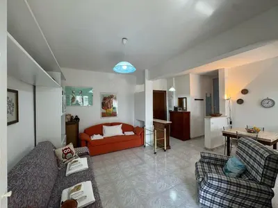 a living room with a red couch and a table at Studio in the Green Roma in Rome