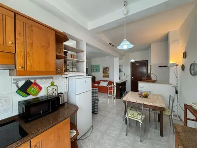 a kitchen with a table and a dining room at Studio in the Green Roma in Rome