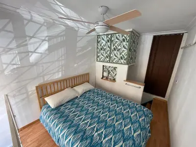 a bedroom with a bed with a ceiling fan at AT Simone Cavallini in Rome