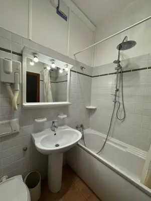a bathroom with a sink and a tub and a toilet at TatyHouse in Rome