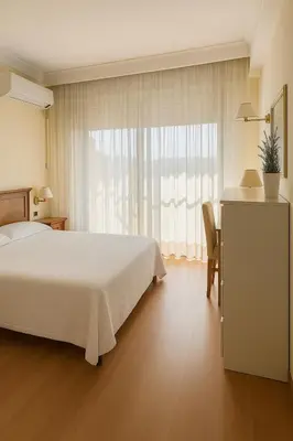 a bedroom with a white bed and a window at TatyHouse in Rome
