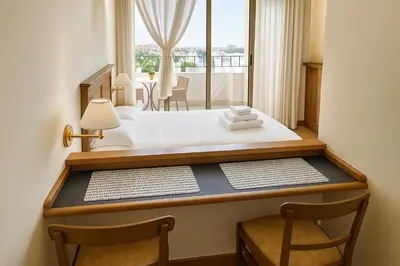 a bedroom with a bed with a desk and a window at TatyHouse in Rome