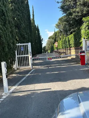 a gate on the side of a road with trees at TatyHouse in Rome