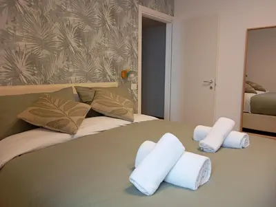 a bedroom with a bed with towels on it at Grazioso e moderno nuovo appartamento in Rome