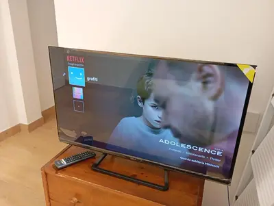 a flat screen tv sitting on a table with a remote control at Grazioso e moderno nuovo appartamento in Rome