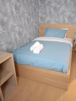 a bedroom with a bed with two towels on it at Grazioso e moderno nuovo appartamento in Rome