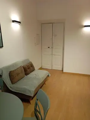 a living room with a couch and a table and chairs at Grazioso e moderno nuovo appartamento in Rome