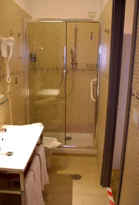 a bathroom with a shower and a sink and a toilet at Vatican Golden Rooms in Rome