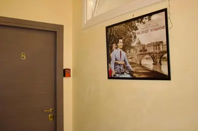 a picture of a man on a wall next to a door at Vatican Golden Rooms in Rome