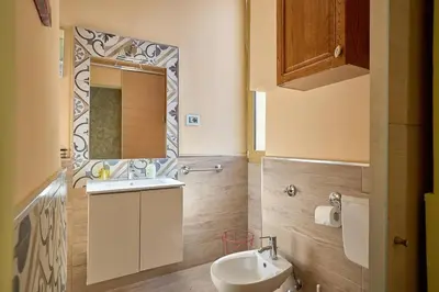 a bathroom with a sink and a toilet and a mirror at Casa Tembien in Rome in Rome