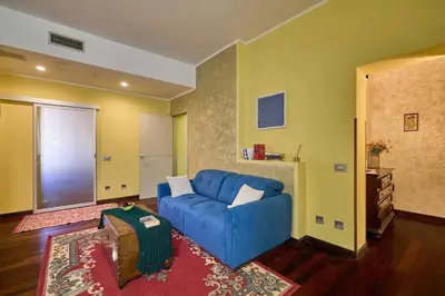 a living room with a blue couch and a rug at Casa Tembien in Rome in Rome