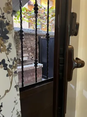 a glass door with a view of a brick wall at Machiavelli's House in Rome