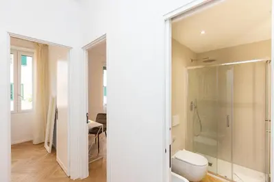 a bathroom with a toilet and a glass shower at Amazing Monteverde in Rome