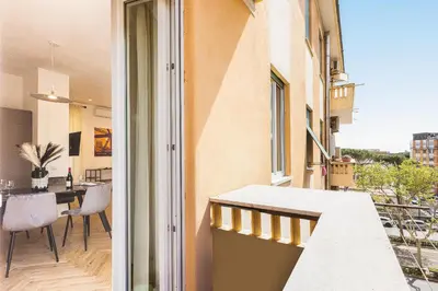 an apartment balcony with a view of a dining area at Amazing Monteverde in Rome