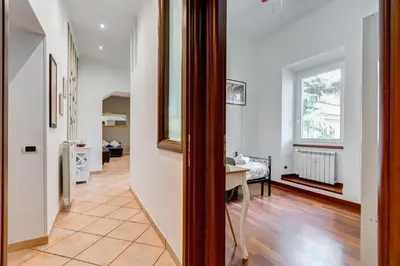 a hallway of a home with white walls and wooden floors at Villa Riccio-Flaminio House in Rome