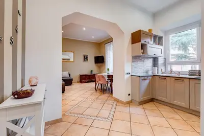 a kitchen and living room with a table and a window at Villa Riccio-Flaminio House in Rome