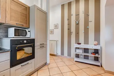 a kitchen with a stove and a microwave at Villa Riccio-Flaminio House in Rome