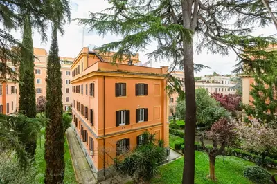 an orange building in a park with trees at Villa Riccio-Flaminio House in Rome