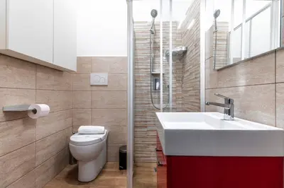a bathroom with a sink and a toilet and a window at Mami Garden in Rome