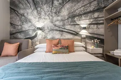 a bedroom with a large bed with a wall mural at Guest House Colosseo Terrestre in Rome
