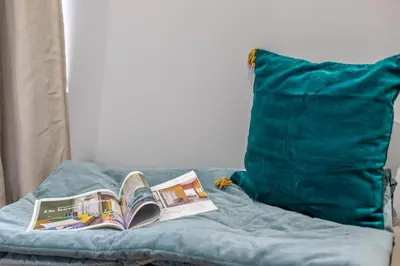 a book sitting on a bed next to a pillow at Guest House Colosseo Terrestre in Rome