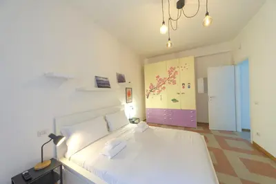 a bedroom with a large white bed in a room at Clodia Holiday Home in Rome