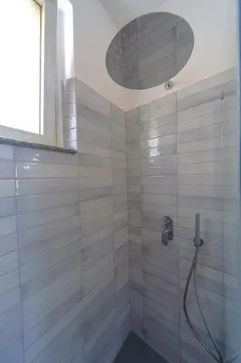 a bathroom with a shower with a shower head at Clodia Holiday Home in Rome