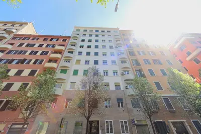 a tall white building with trees in front of it at Clodia Holiday Home in Rome