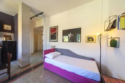 a bedroom with a purple bed in a room at Clodia Holiday Home in Rome