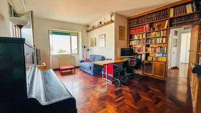 a living room with a desk and bookshelves at Pinuz Guest House in Rome