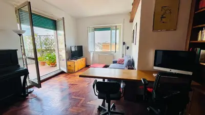 a living room with a desk and a table with chairs at Pinuz Guest House in Rome