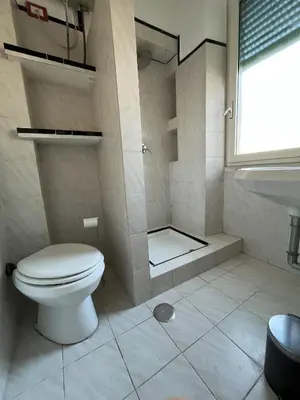 a bathroom with a toilet and a sink at Pinuz Guest House in Rome
