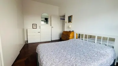 a bedroom with a bed and a dresser and a mirror at Pinuz Guest House in Rome