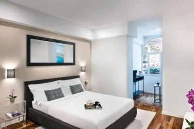 a bedroom with a large white bed and a window at Piazza di spagna 32 Fellini Design Suites in Rome