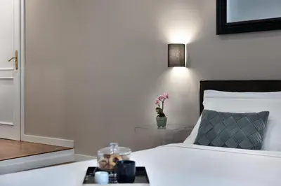 a bedroom with a white bed with a tray on it at Piazza di spagna 32 Fellini Design Suites in Rome